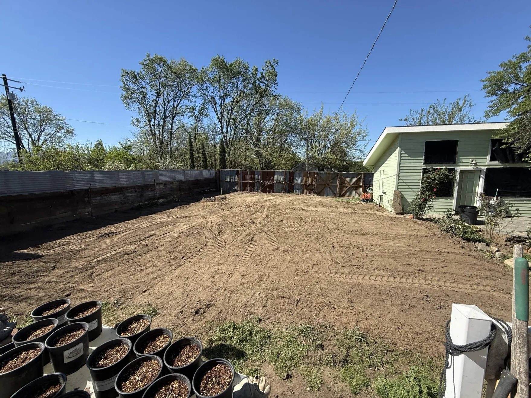 Freshly graded residential yard beside a residential building.